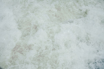 the concept of boating, relaxing at sea - splashes of blue water in the sea close-up