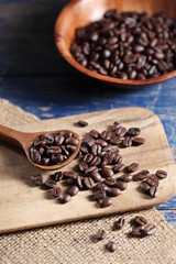 Coffee beans in wooden spoon on rustic wooden table with a blank space for a text, Coffee in cup on loft background