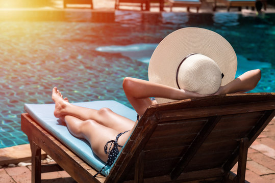 Asian Young Women Relaxing Sleep Poolside At Luxury Swimming Pool