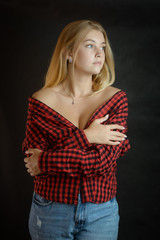 Fototapeta premium Portrait of beautiful woman with blue eyes in black-red shirt.