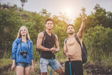 Adventure themed travel and hiking trips, Hikers, Groups of tourists with backpacks and camera with walking down the mountain path. © Sumala