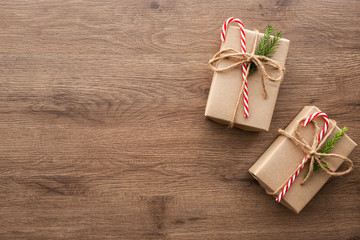 Two brown gift boxes are on top of wood table. Merry Christmas and happy new year concept. Top view with copy space, flat lay.