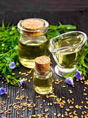 Oil flaxseed on dark wooden board