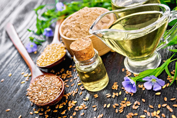 Oil flaxseed with flour and seeds on black board