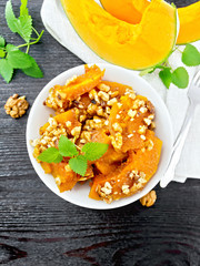 Pumpkin with nuts and honey on wooden board top