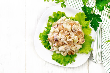 Salad of salmon and cucumber in plate on board top