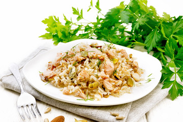 Salad of salmon and rice in plate on board