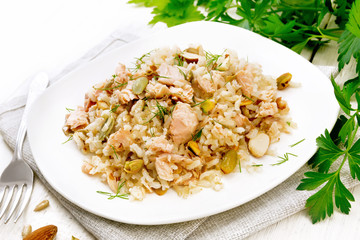 Salad of salmon and rice in plate on white board