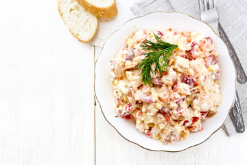Salad with chicken and vegetables in plate on board top