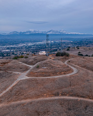 Aerial view of open rolling hills in suburban Southern California.  Radio tower atop hill during...