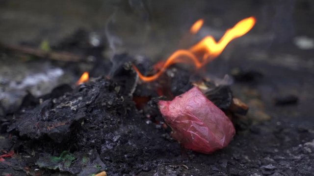 Trash is being burned on a small fire place