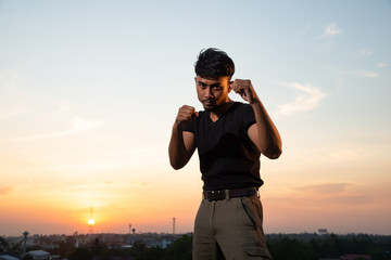man posing mauy thai in rooftop
