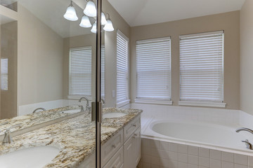 Large bathtub and double windows  in contemporary home master bath