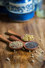 spices in spoons on wooden background