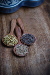 Spices and herbs in wooden spoons