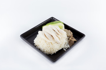 Hainanese chicken rice or steamed chicken rice served on square shape dish isolated on white background.