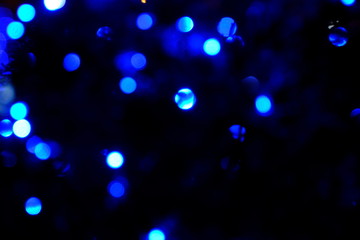  Garland lights on the Christmas tree. Blurred defocused christmas background for design.