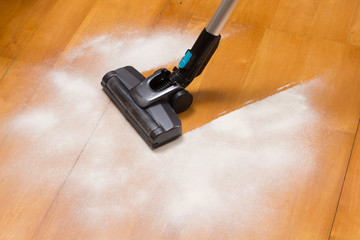 vacuum cleaner brush cleaning flour on the floor