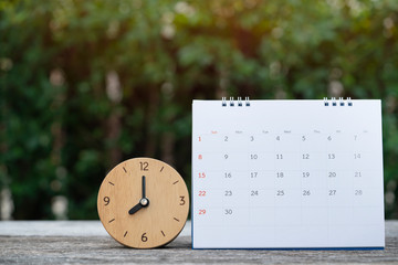 close up of calendar and clock on the table for planner business management schedule concept.