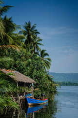 Fototapeta na wymiar boat and jungle hut on the tatai river in cambodia