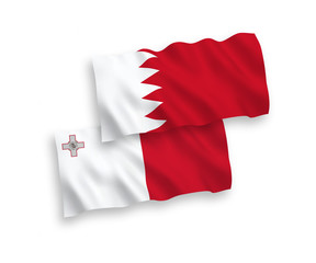 National vector fabric wave flags of Malta and Bahrain isolated on white background. 1 to 2 proportion.