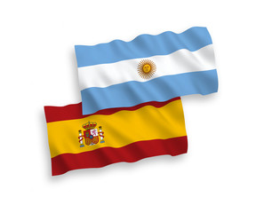 National vector fabric wave flags of Argentina and Spain isolated on white background. 1 to 2 proportion.