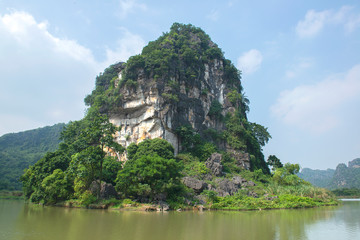 Fototapeta na wymiar Panoramic view of karst formations in Tam Coc, a part of Trang An Complex , was declared a UNESCO World Heritage Natural and Cultural Monument.Ninh Binh province, Vietnam