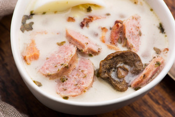 Traditional easter white borscht with eggs and sausage