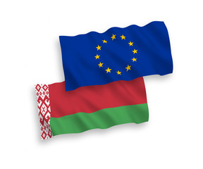National vector fabric wave flags of European Union and Belarus isolated on white background. 1 to 2 proportion.