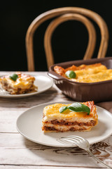Plate with tasty baked lasagna on table