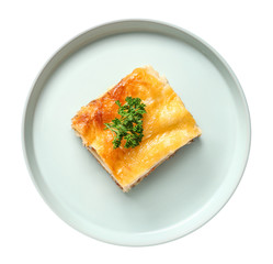 Plate with tasty baked lasagna on white background