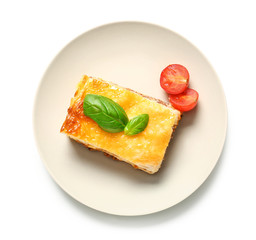 Plate with tasty baked lasagna on white background