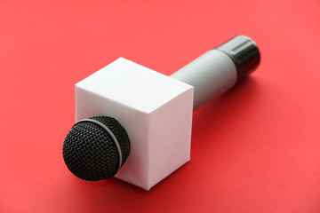 Journalist's microphone on color background
