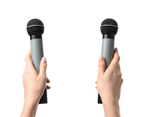 Female hands with microphones on white background