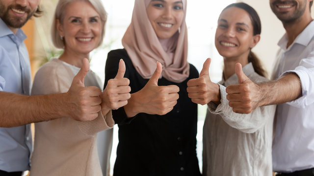 Happy multiracial diverse people showing thumbs up gesture.