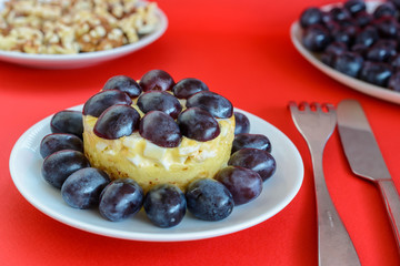 The legendary Tiffany layered salad with grapes, chicken and cheese on the red background.