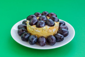 The legendary Tiffany layered salad with grapes, chicken and cheese on the green background.