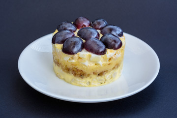 The legendary Tiffany layered salad with grapes, chicken and cheese on the black background.