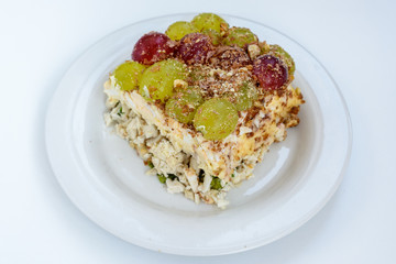 The legendary Tiffany layered salad with grapes, chicken and cheese on the white background.