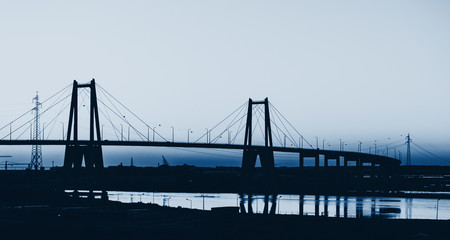 Silhouette of the suspension bridge blue toned