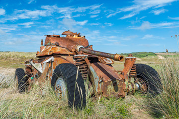 Memorials of WWII: A rusty tank in the bombed dunes near Biville, Normandy, France.