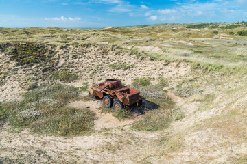 Memorials of WWII: A rusty tank in the bombed dunes near Biville, Normandy, France.