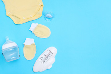 Lovely baby accessories on blue background . Copy space Top view Flat lay