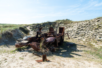 Memorials of WWII: A rusty tank in the bombed dunes near Biville, Normandy, France.