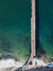 Top down aerial view of a jetty on the water.