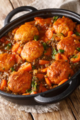 Steamed meatballs turkey with lentils and vegetables close-up in a pan. vertical