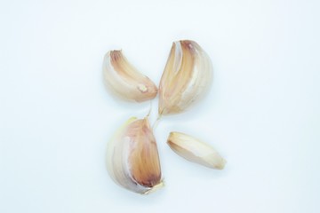 Garlic cloves located on a white background