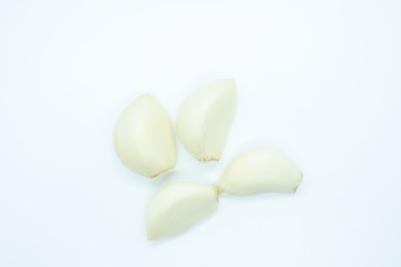 Garlic cloves located on a white background