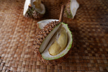 Delicious Indonesian ripe durian, presented on a traditional pandanus mat