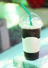 Iced americano coffee with ice on table in cafe at outdoor.